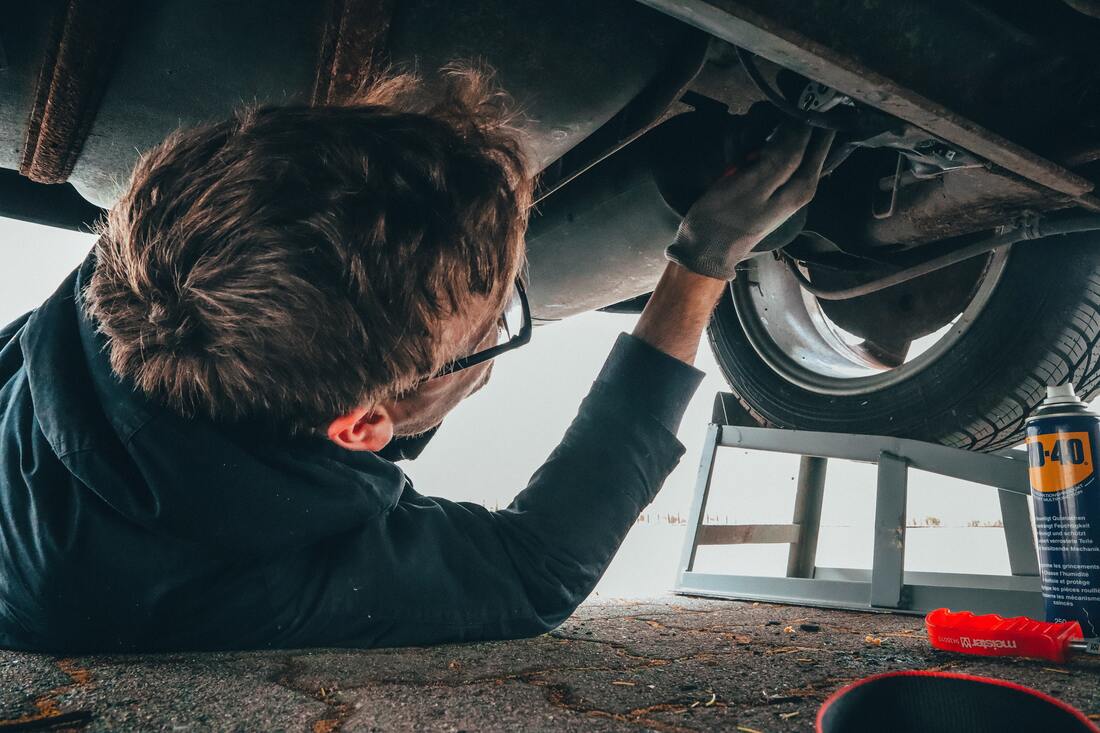 Car mechanic doing an oil change